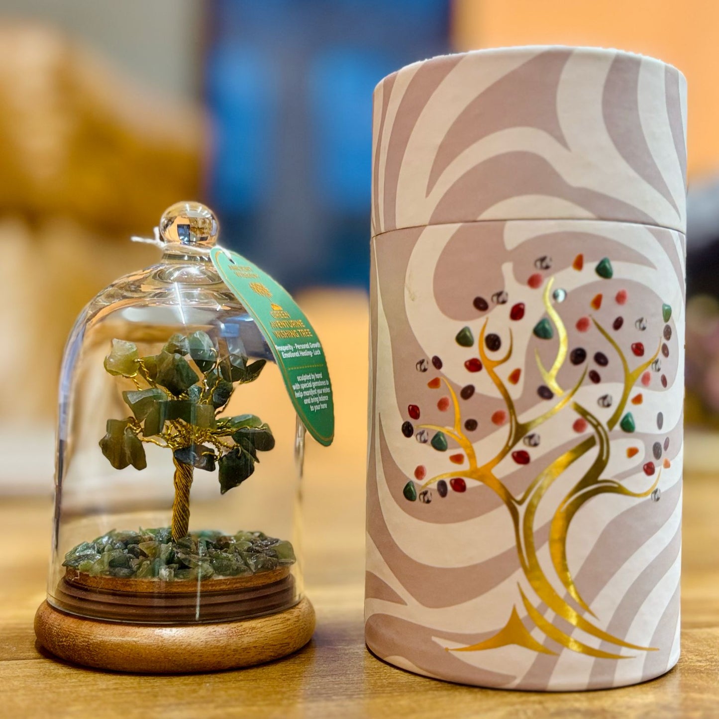 Small glass dome containing a Aventurine gemstone tree with gold trunk with Aventurine chips scattered on the ground.