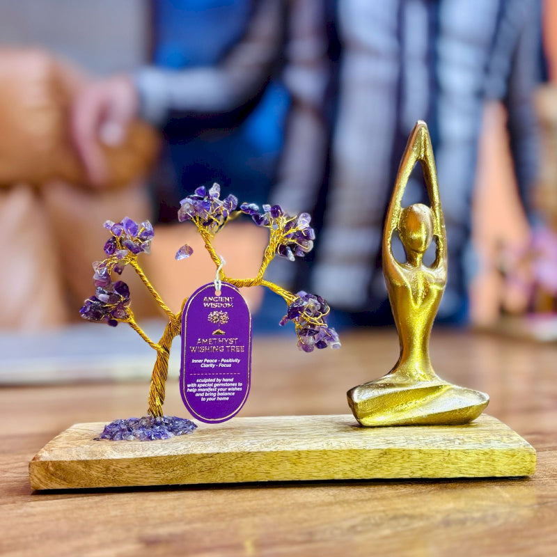 Amethyst Yoga Garden with gold statue doing Sukhasana Pose