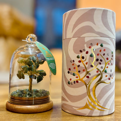 Small glass dome containing a Aventurine gemstone tree with gold trunk with Aventurine chips scattered on the ground.