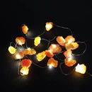 String of colorful rock-shaped lights on a black background