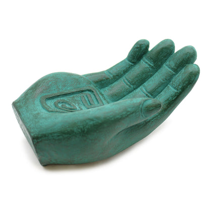 Green hand-shaped incense burner with incense stick with white background