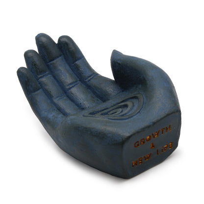 Blue hand-shaped incense burner with white background