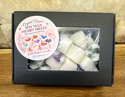 Box of crystal-topped soy wax heart melts with a decorative label on a wooden surface.