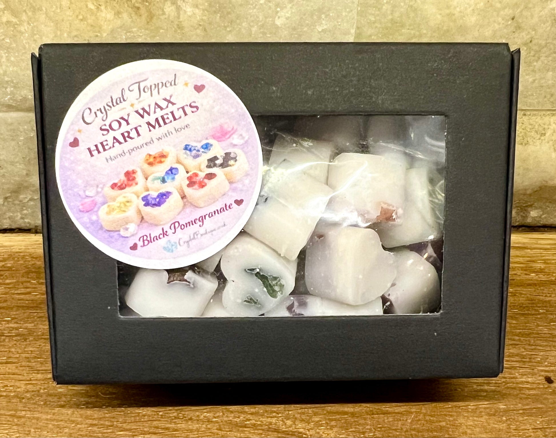 Box of Crystal Topped Soy Wax Heart Melts with a label on a wooden surface