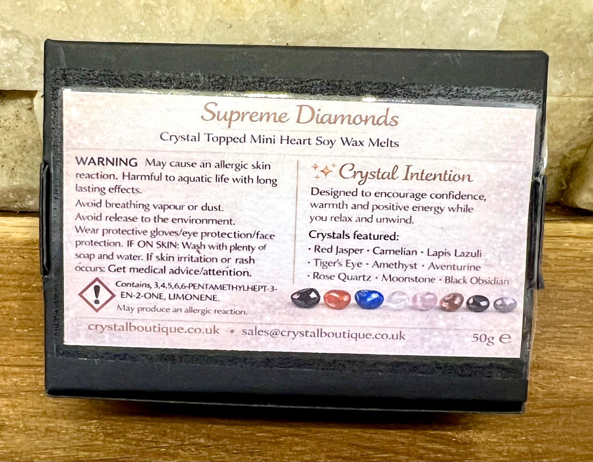 Box of Supreme Diamonds crystal-topped mini heart soy wax melts on a wooden surface.
