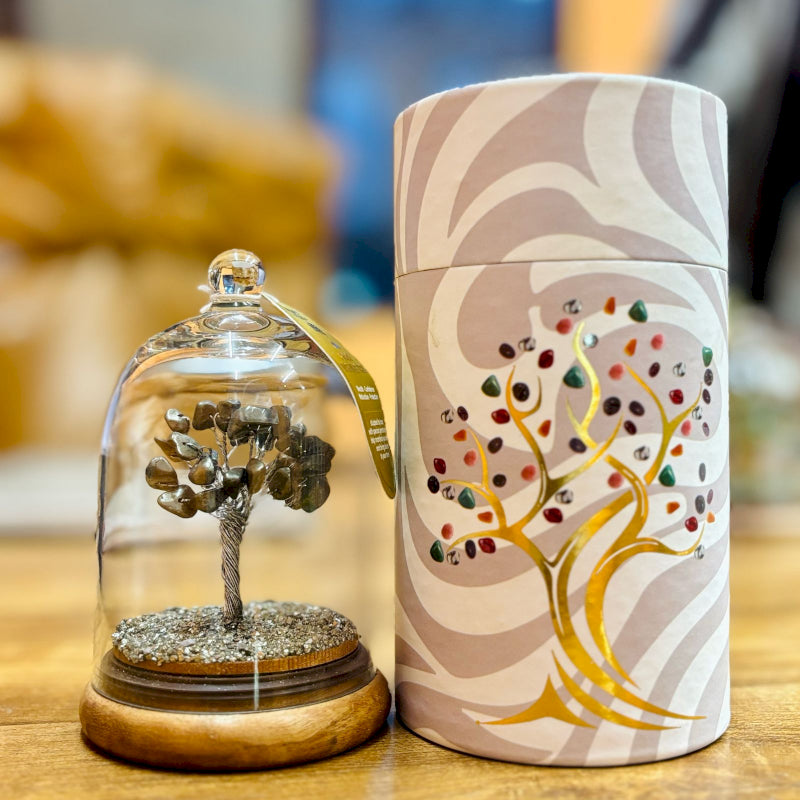 Small glass dome containing a Pyrite gemstone tree with gold trunk with Pyrite chips scattered on the ground.