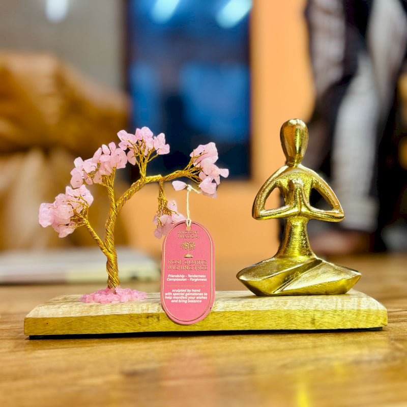 Rose Quartz Yoga Garden with gold statue doing Namaste Pose on wooden base